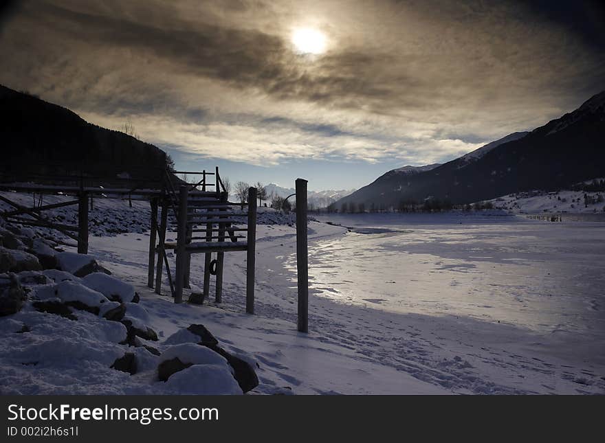 It shows a frozen lake with view to the highest montains in Italy. It shows a frozen lake with view to the highest montains in Italy