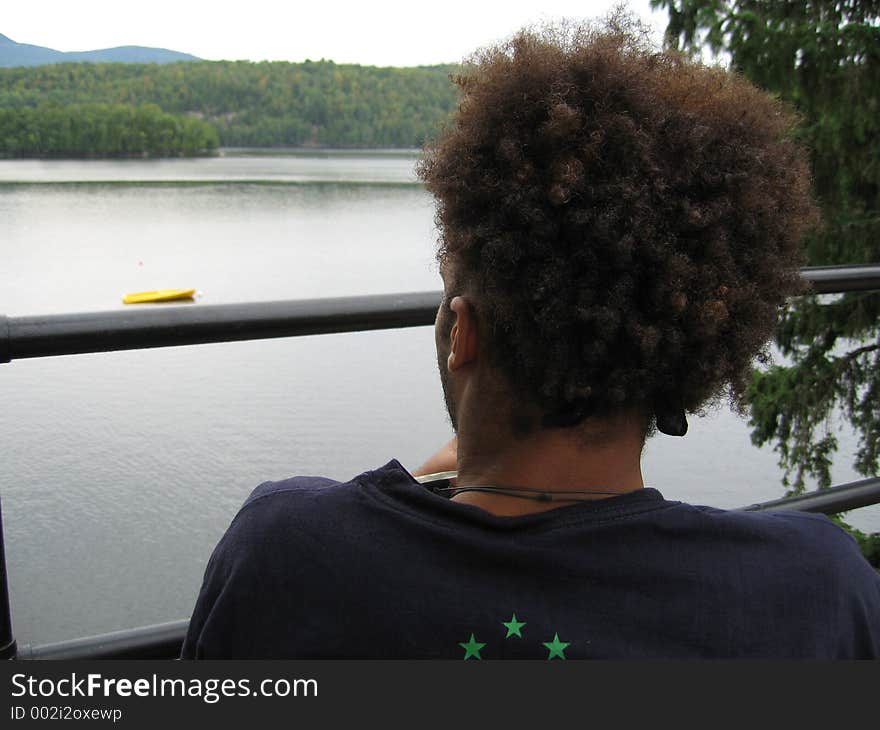 Teenager with Afro looking at Lake. Teenager with Afro looking at Lake