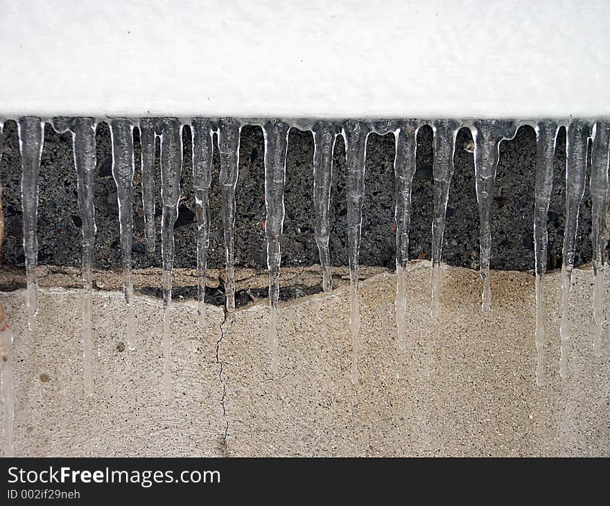 Icicles hanging on the side of a house