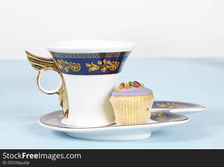 Teacup and cake on a table - landscape version. Teacup and cake on a table - landscape version