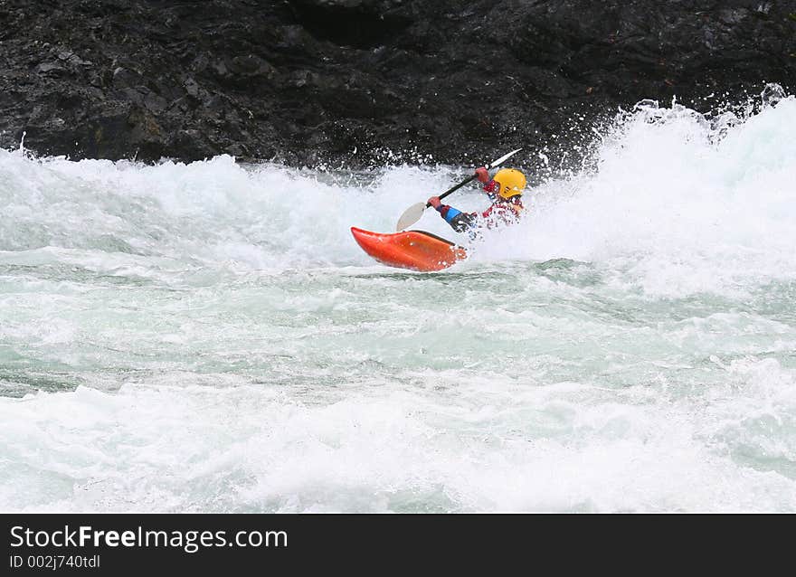 A kayaker braking the waves