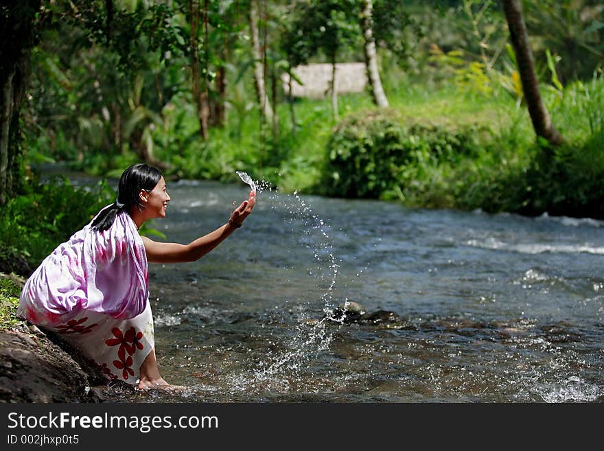 Attractive Asian woman playing with water. Attractive Asian woman playing with water.