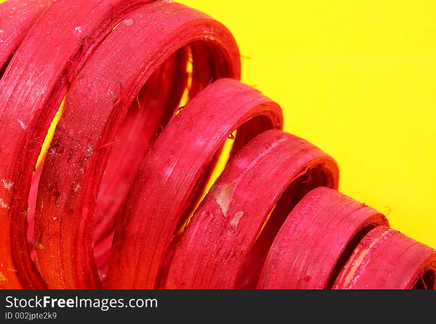 Curled Red Wood on a Yellow Background. Curled Red Wood on a Yellow Background