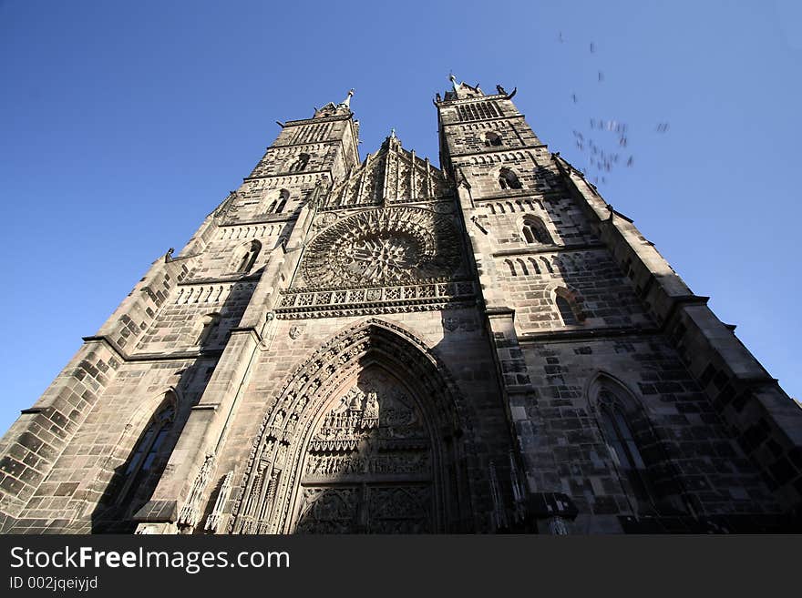 Old Building in Nuremburg Market. Taken with a wide angle lense ground up.Birds flying on side.Motion Blur for birds.