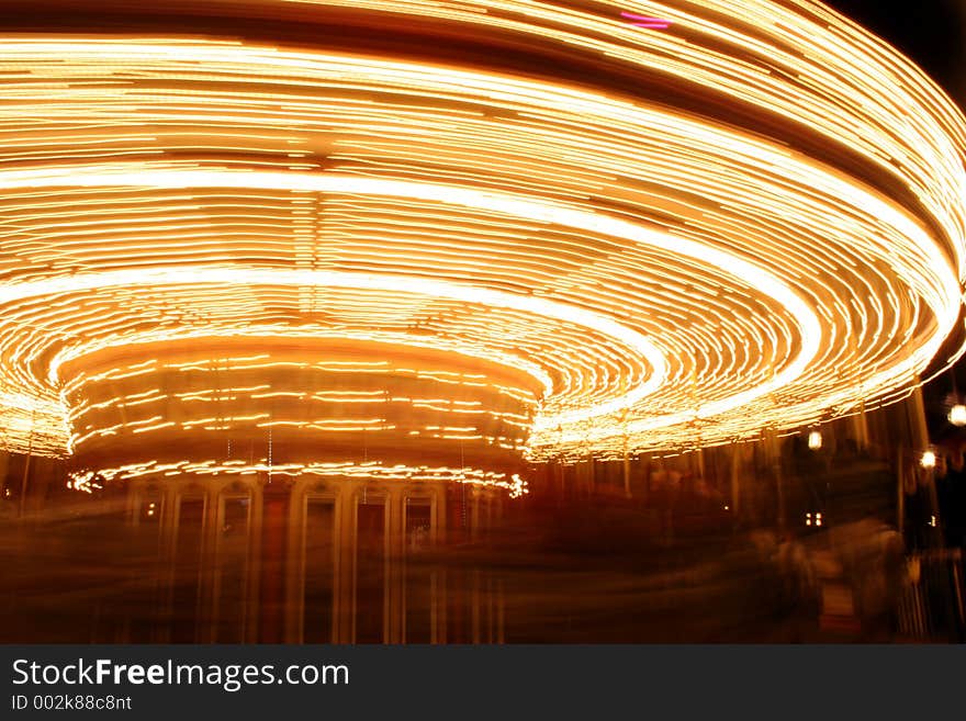 The blurred movement of lights on a carousel ride. The blurred movement of lights on a carousel ride.