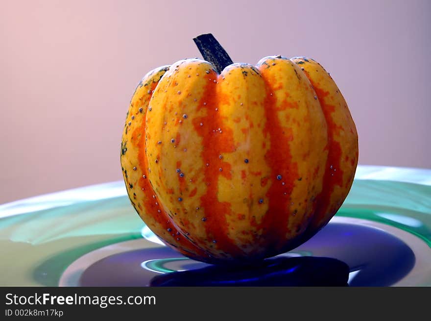 A pumpkin on a glass plate. A pumpkin on a glass plate