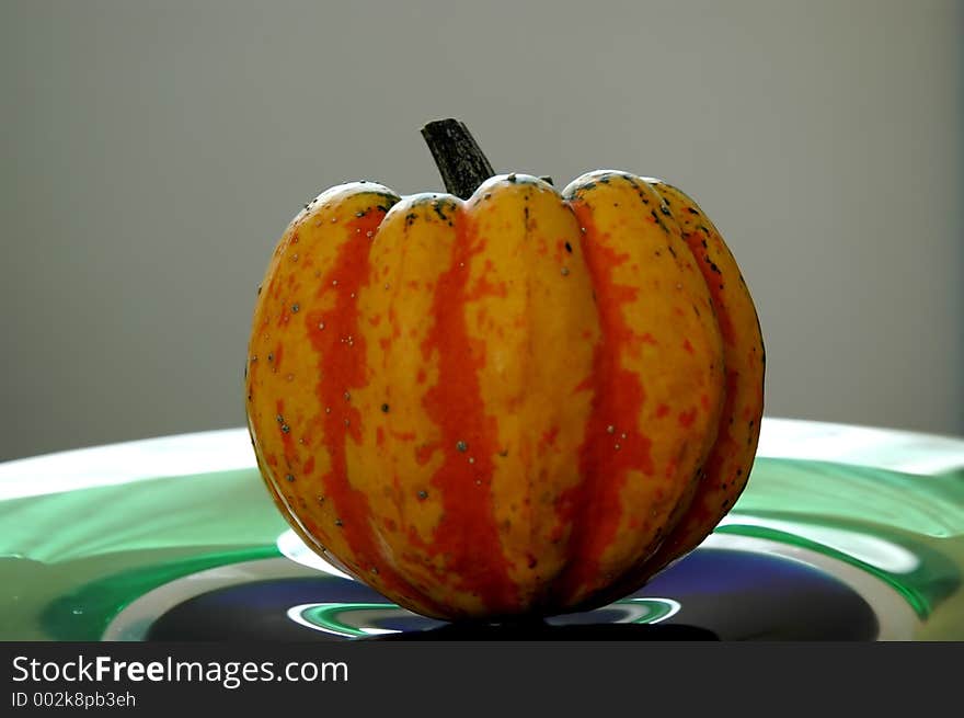 A pumpkin on a glass plate. A pumpkin on a glass plate