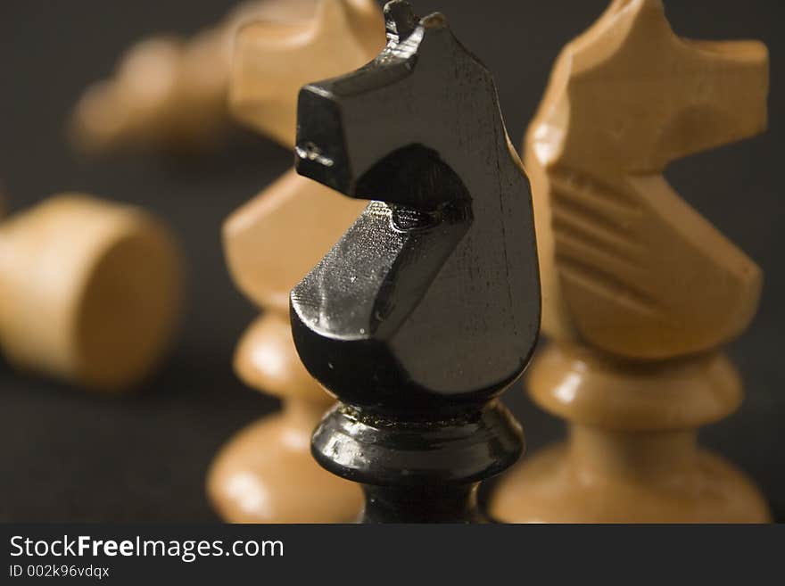 Three chess horses on dark background