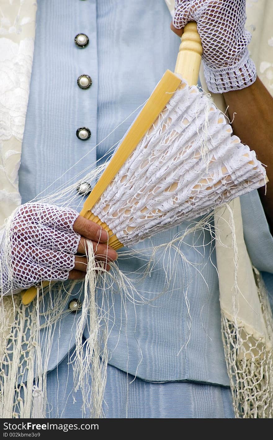 Woman in period clothes holding fan and wearing lacy gloves. Woman in period clothes holding fan and wearing lacy gloves