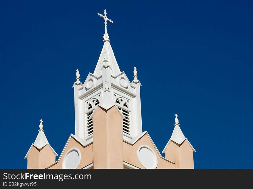 Spires, steeples and bell tower of the Catholic mission church in the Old Town Plaza of Albuquerque, New Mexico - horizontal orientation. Spires, steeples and bell tower of the Catholic mission church in the Old Town Plaza of Albuquerque, New Mexico - horizontal orientation.