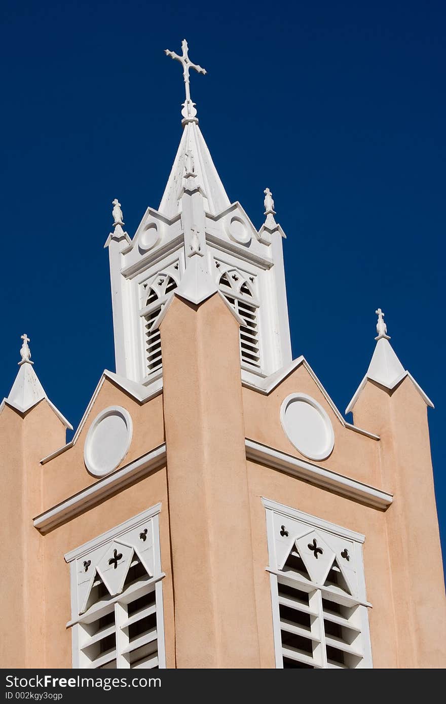 Spires, steeples, and bell tower of the Spanish colonial era Catholic church in the Old Town Plaza of Albuquerque, New Mexico - vertical orientation. Spires, steeples, and bell tower of the Spanish colonial era Catholic church in the Old Town Plaza of Albuquerque, New Mexico - vertical orientation.