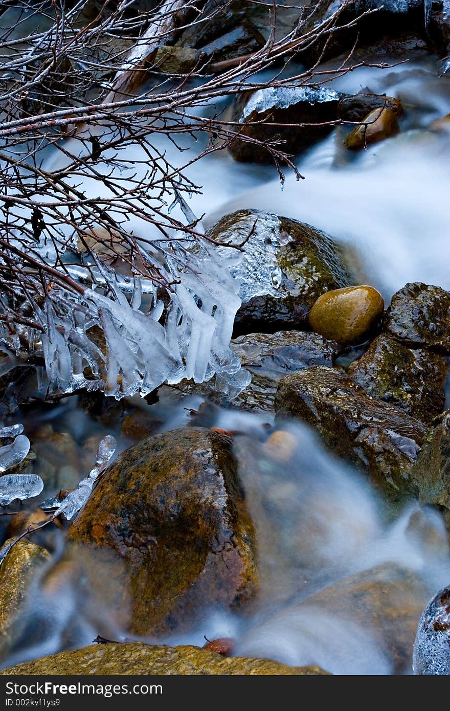 An icy mountain stream flows through icy channels. An icy mountain stream flows through icy channels.