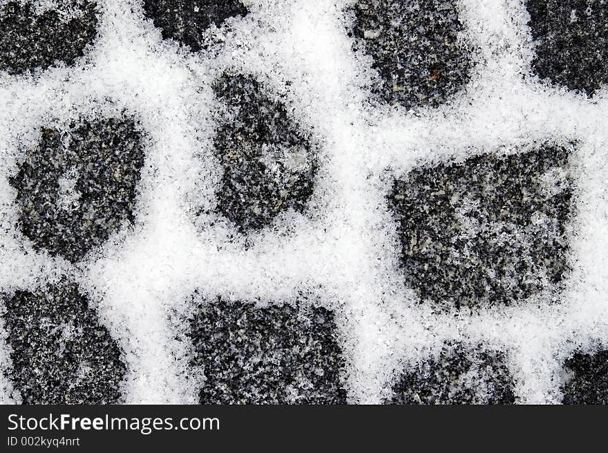 Snowfilled granite pavement gaps make a pattern on the ground. Snowfilled granite pavement gaps make a pattern on the ground