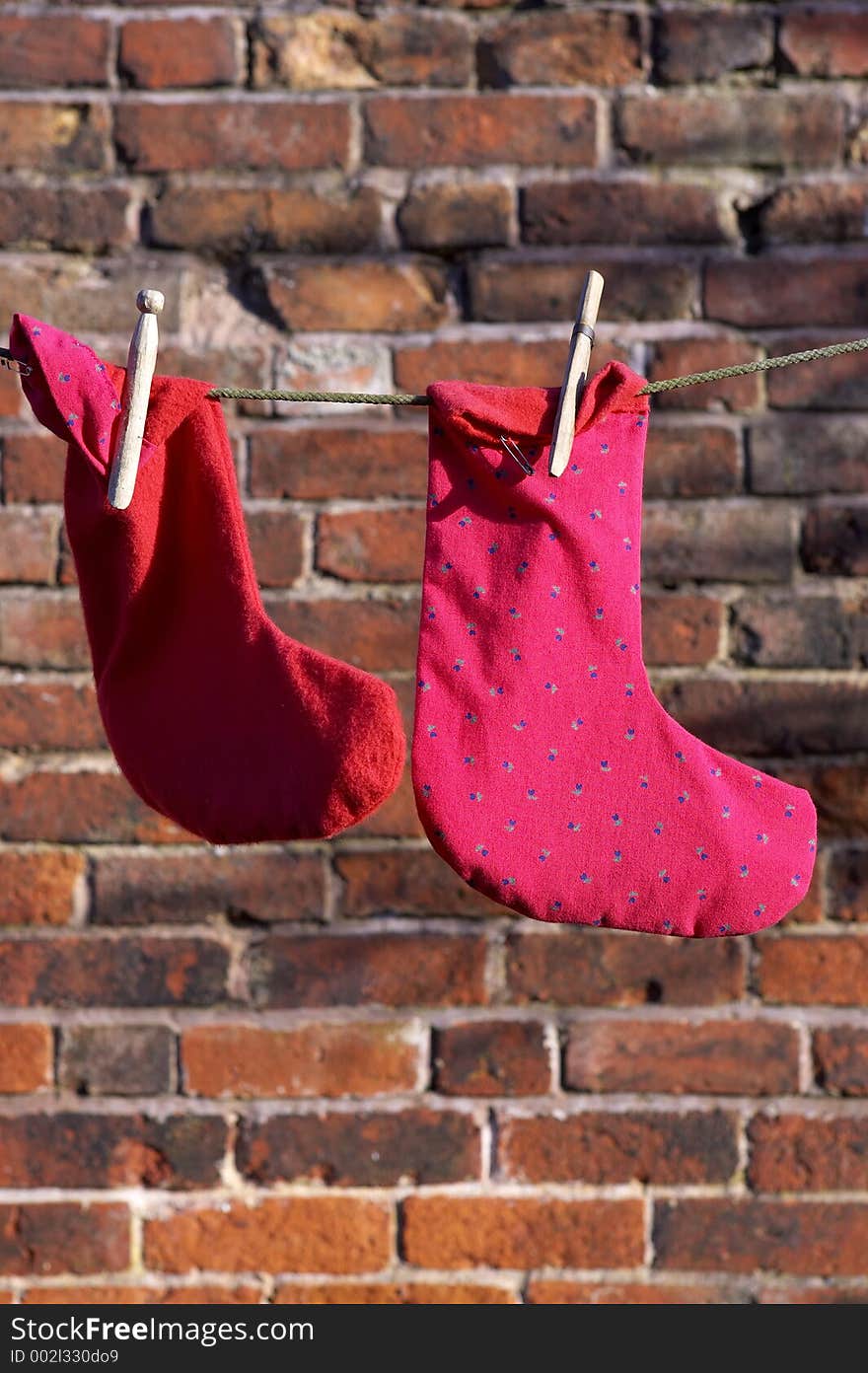 Two socks drying on a washing line