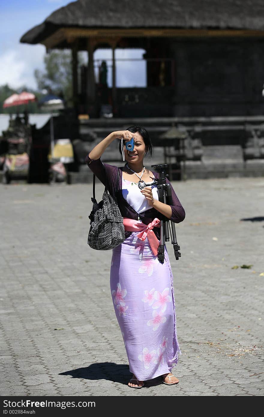 Asian tourist with a camera and a tripod