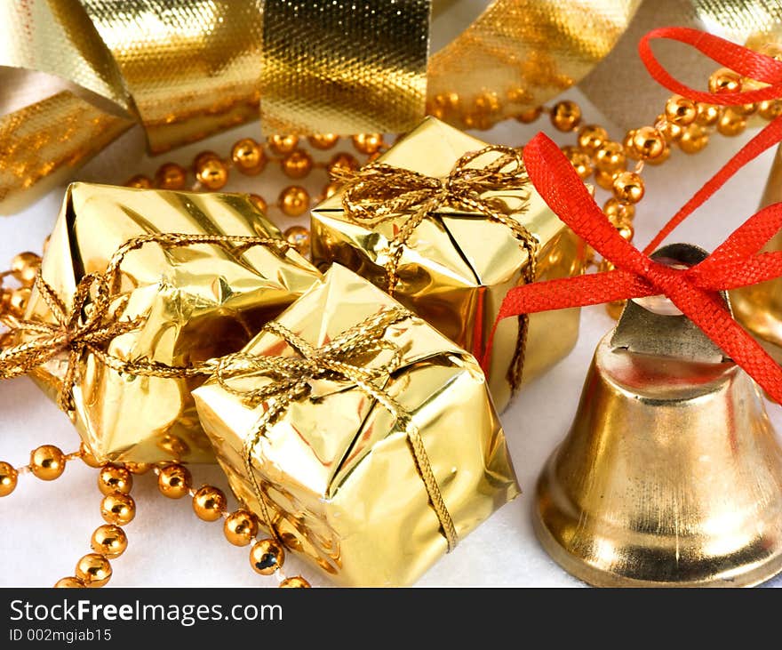 Golden presents and bell with ribbon background. Golden presents and bell with ribbon background