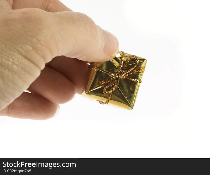 Hand holding small presents isolated over-white. Hand holding small presents isolated over-white