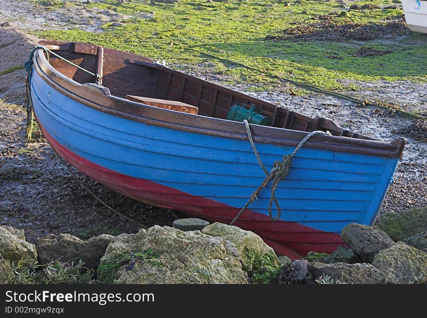 Blue & red rowing boat on land