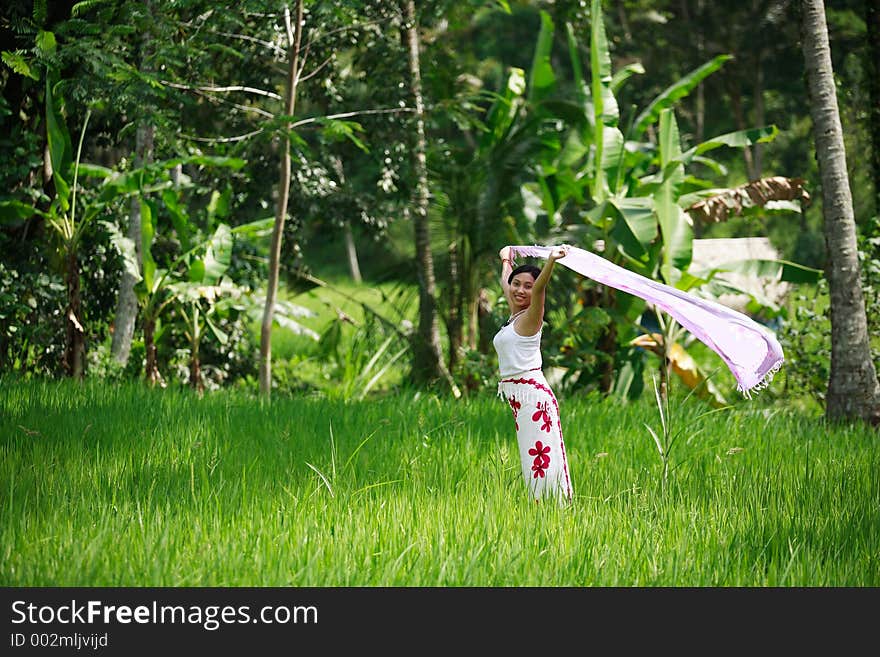 Happy Asian woman with her sarong at rice field. Happy Asian woman with her sarong at rice field