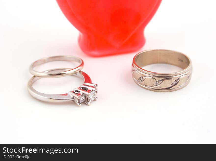 A romantic oil bottle and wedding rings. A romantic oil bottle and wedding rings