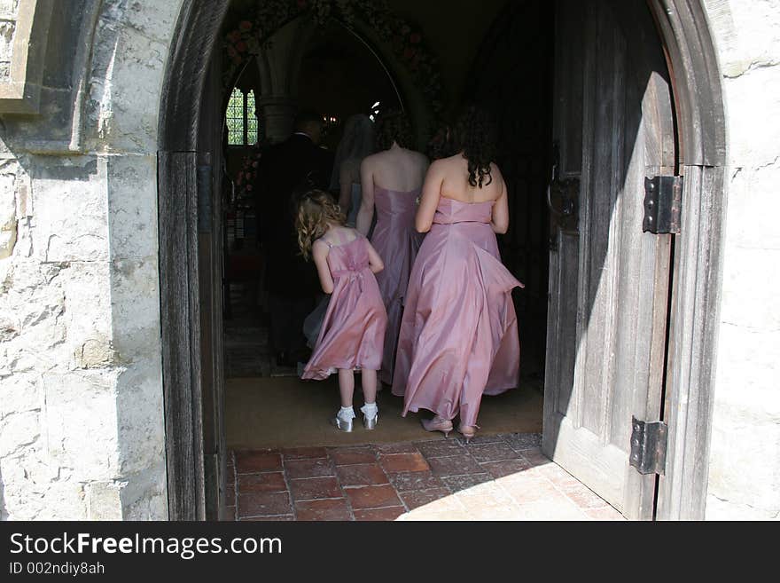 The youngest bridesmaid looks round at the bride. The youngest bridesmaid looks round at the bride