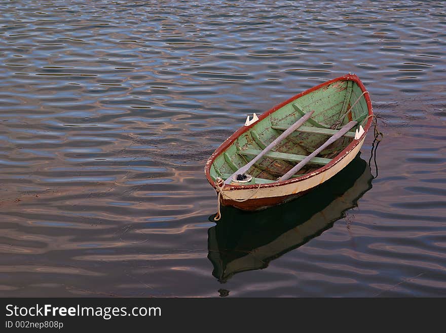 This old wooden norwegian fissinh boat looked quite lonely when i saw it lying there on the sea. i liked the space around it and the colors and painting on the boat, the reflection in the sea. A typical old fishingboat. This old wooden norwegian fissinh boat looked quite lonely when i saw it lying there on the sea. i liked the space around it and the colors and painting on the boat, the reflection in the sea. A typical old fishingboat.