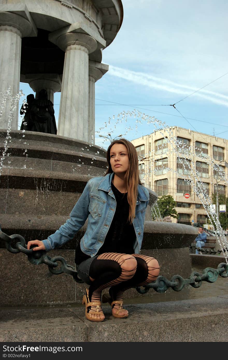 The girl at a fountain in city