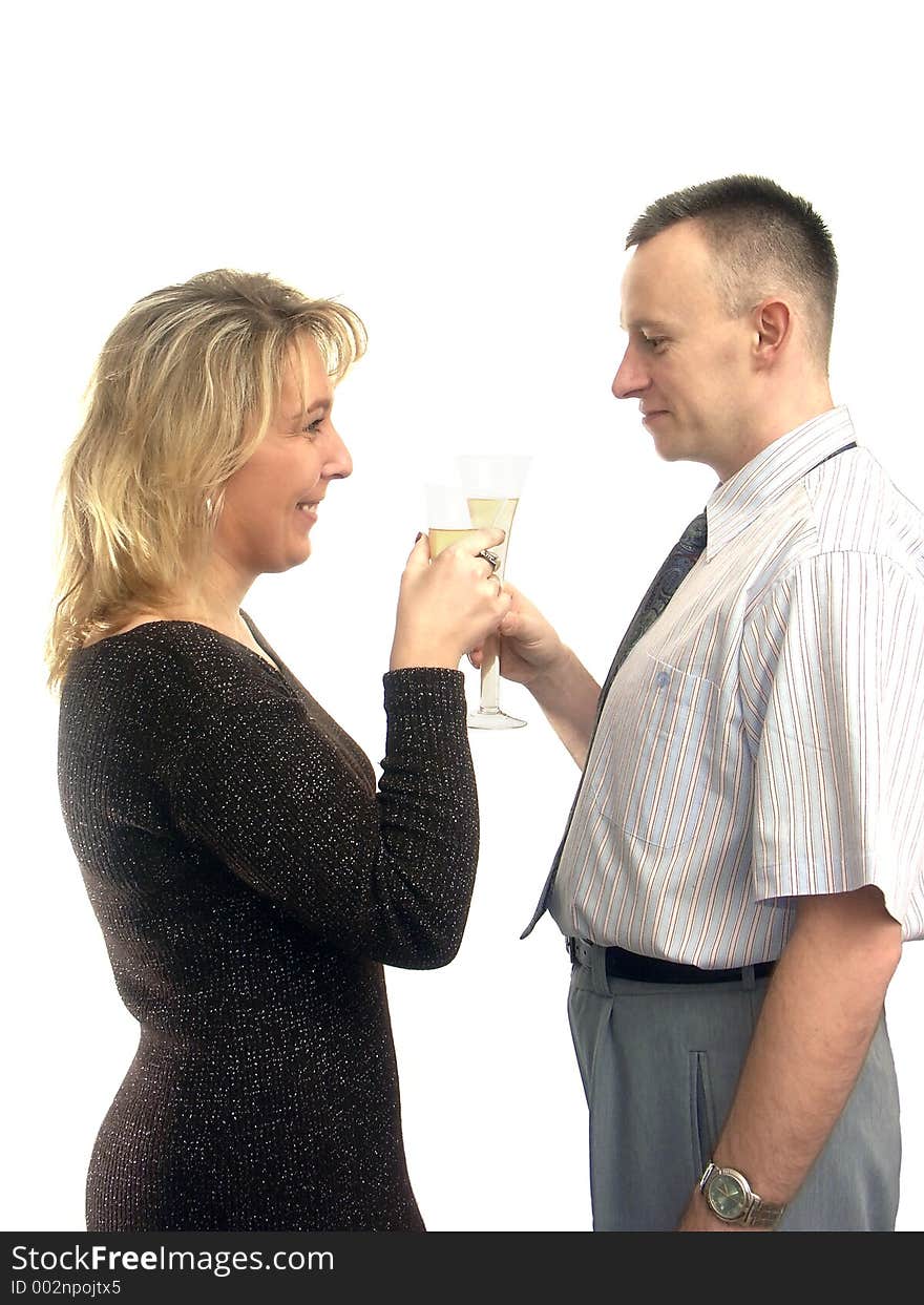 Young couple celebrating with two glasses of champagne over white background. Young couple celebrating with two glasses of champagne over white background