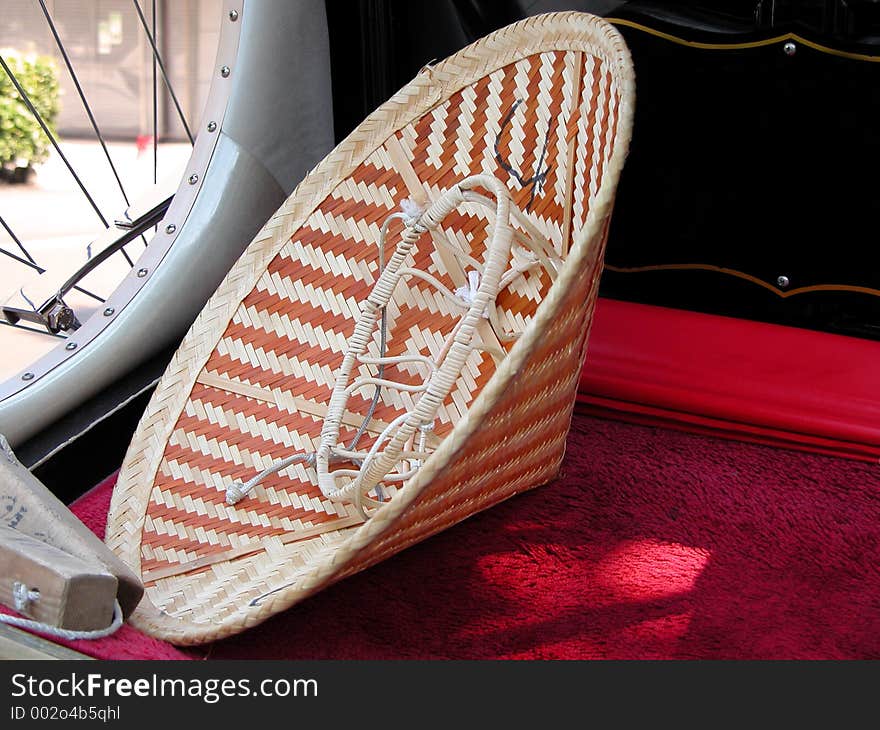 Chinese hat on a rickshaw bench-detail