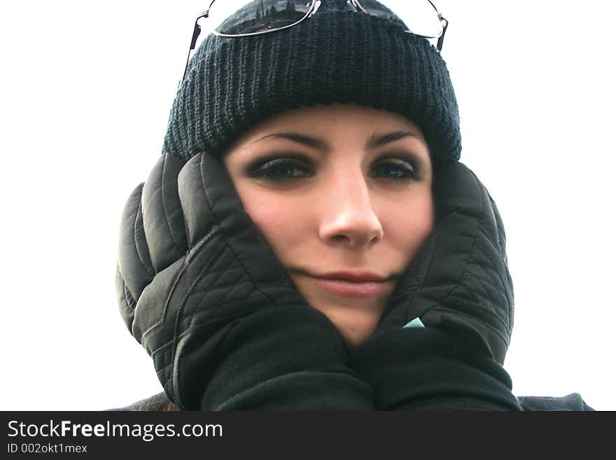 Young woman covers ears with gloved hands in the freezing winter weather. Young woman covers ears with gloved hands in the freezing winter weather.