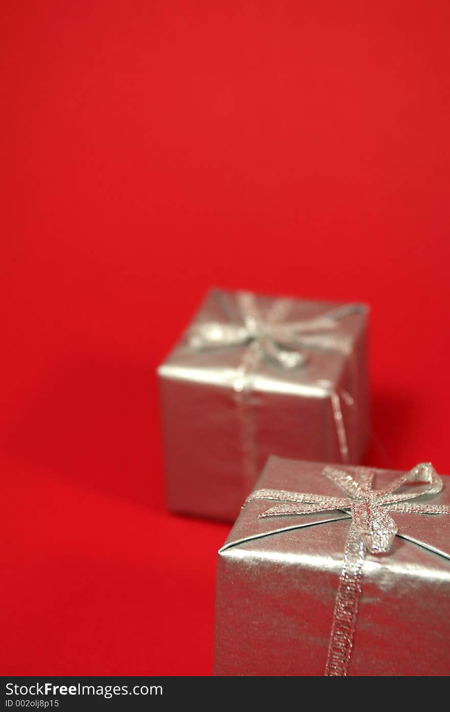 Silver gift boxes with red background