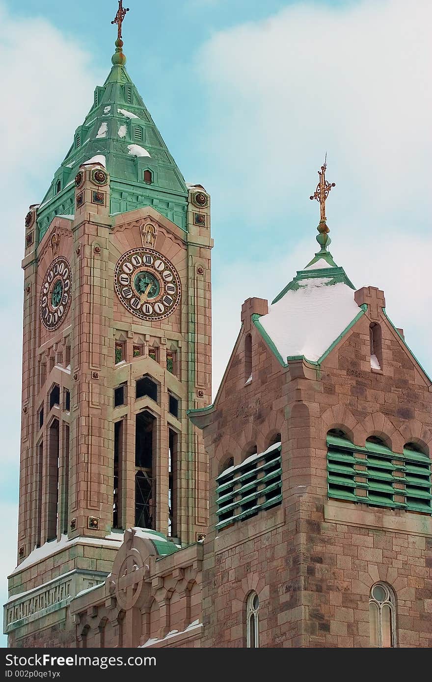 Matching clocks on the faces of a church tower. Matching clocks on the faces of a church tower