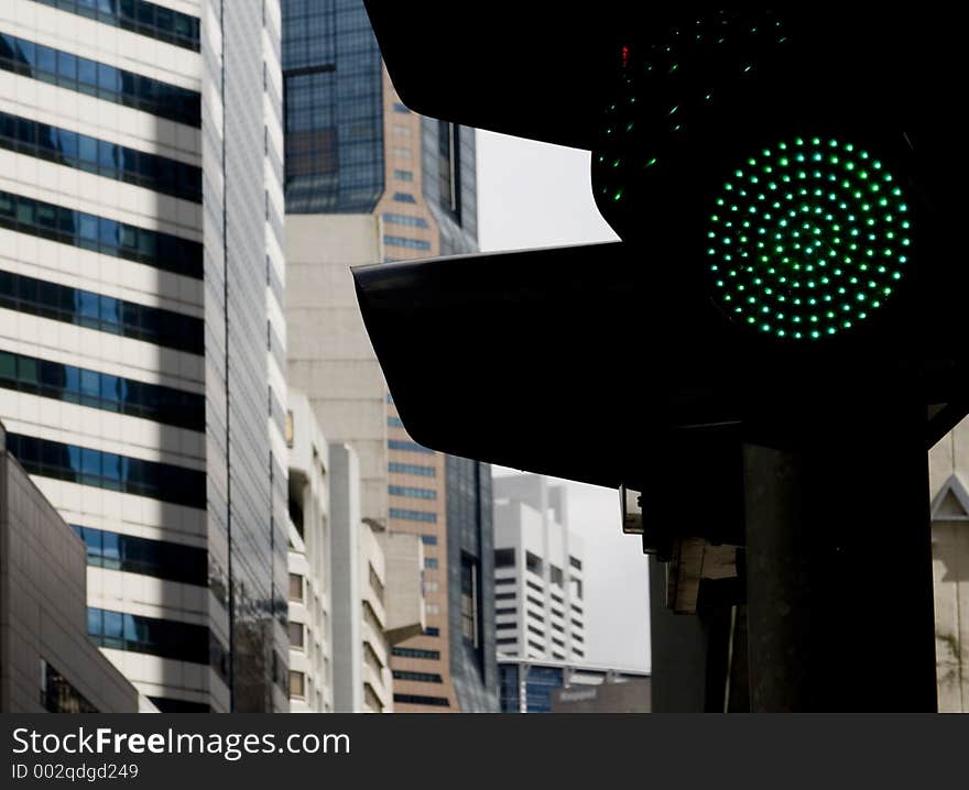 A traffic lights shows green in the business district of Singapore. A traffic lights shows green in the business district of Singapore