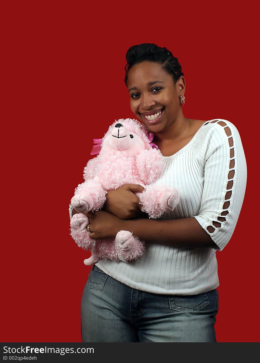 A beautiful young woman holding a pink poodle. A beautiful young woman holding a pink poodle.