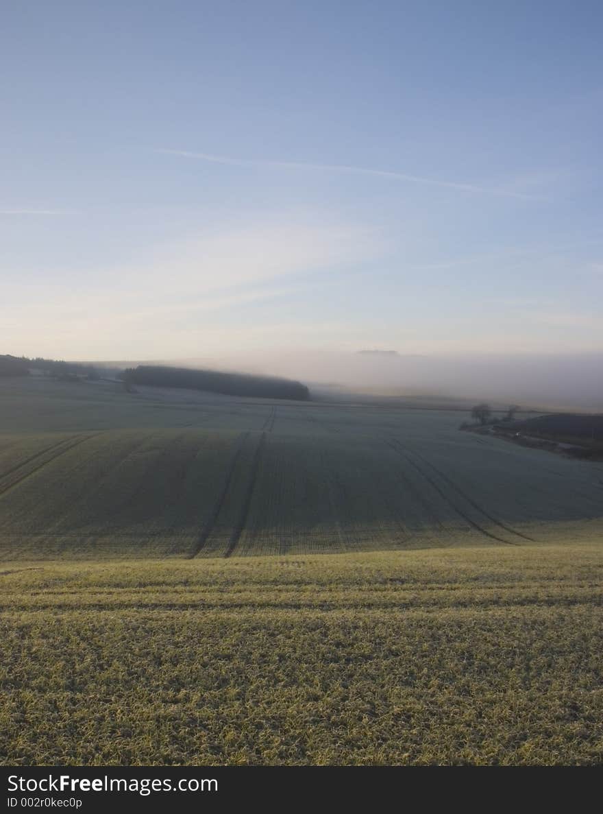 Ploughed field with fog in the distance. Ploughed field with fog in the distance