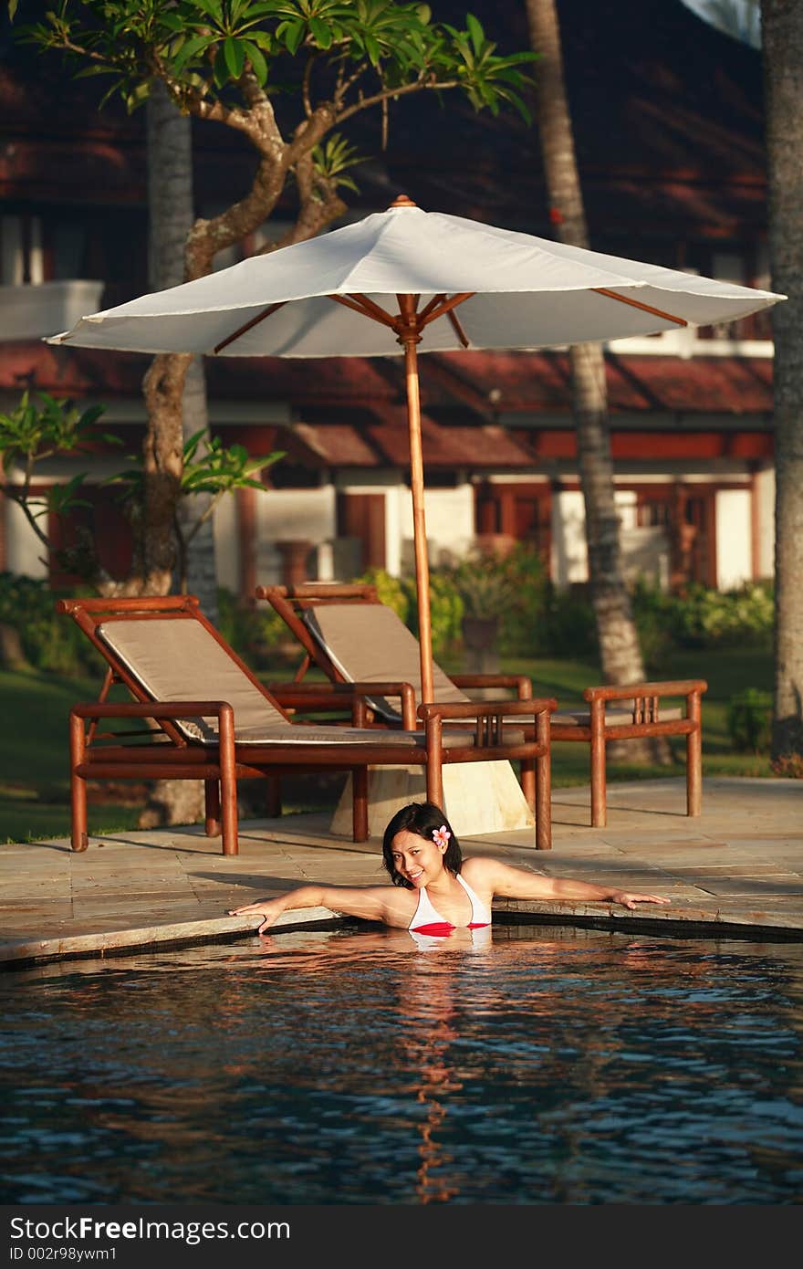 Asian woman enjoying the day at swimming pool. Asian woman enjoying the day at swimming pool