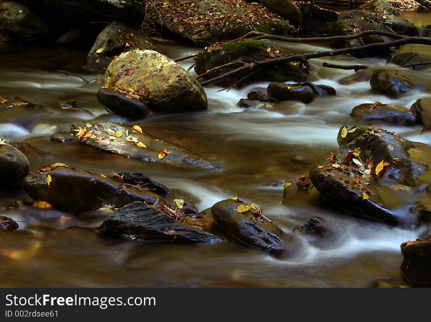 Flowing stream in fall slow exposure. Flowing stream in fall slow exposure