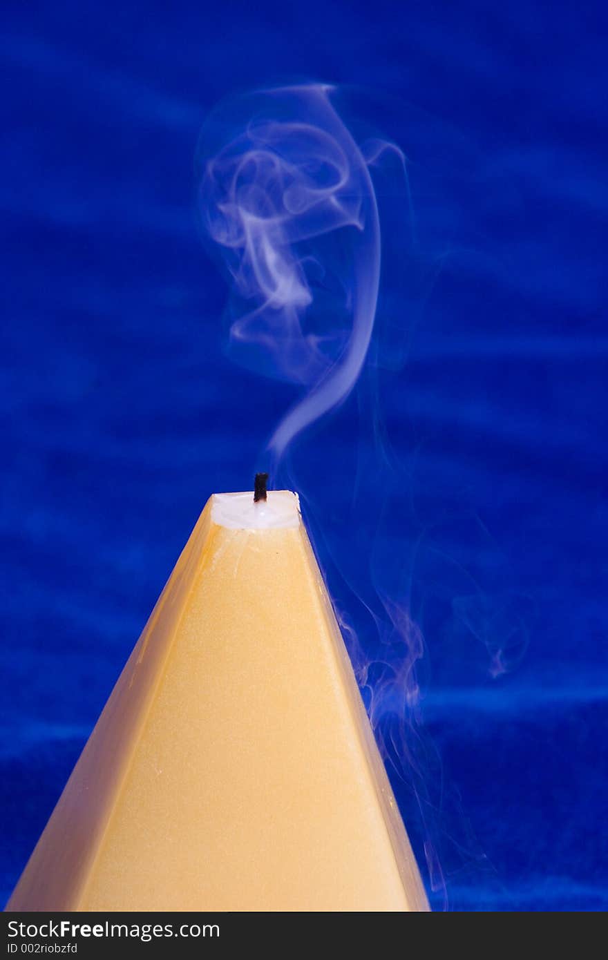 An abstract image on a candle and swirling smoke. An abstract image on a candle and swirling smoke