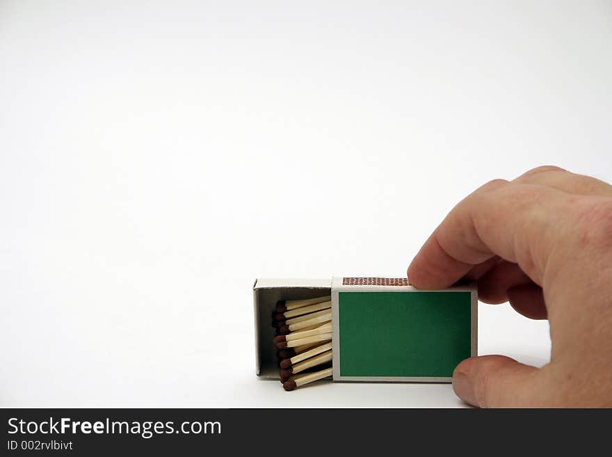 Matches in a green box with hand