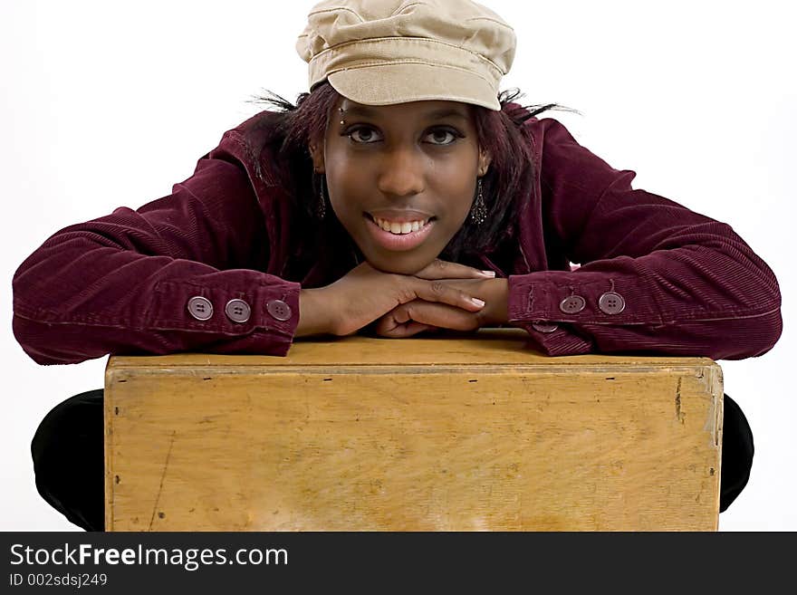 Young black woman leaning on a box with room for copy space