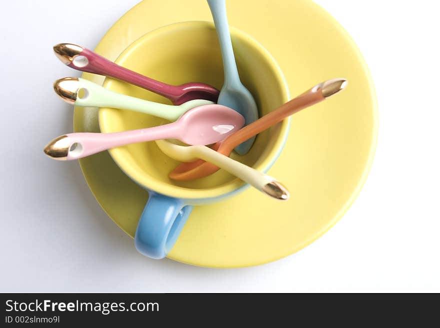 Closeup of some coloured coffee spoons inside a coloured cup. Closeup of some coloured coffee spoons inside a coloured cup