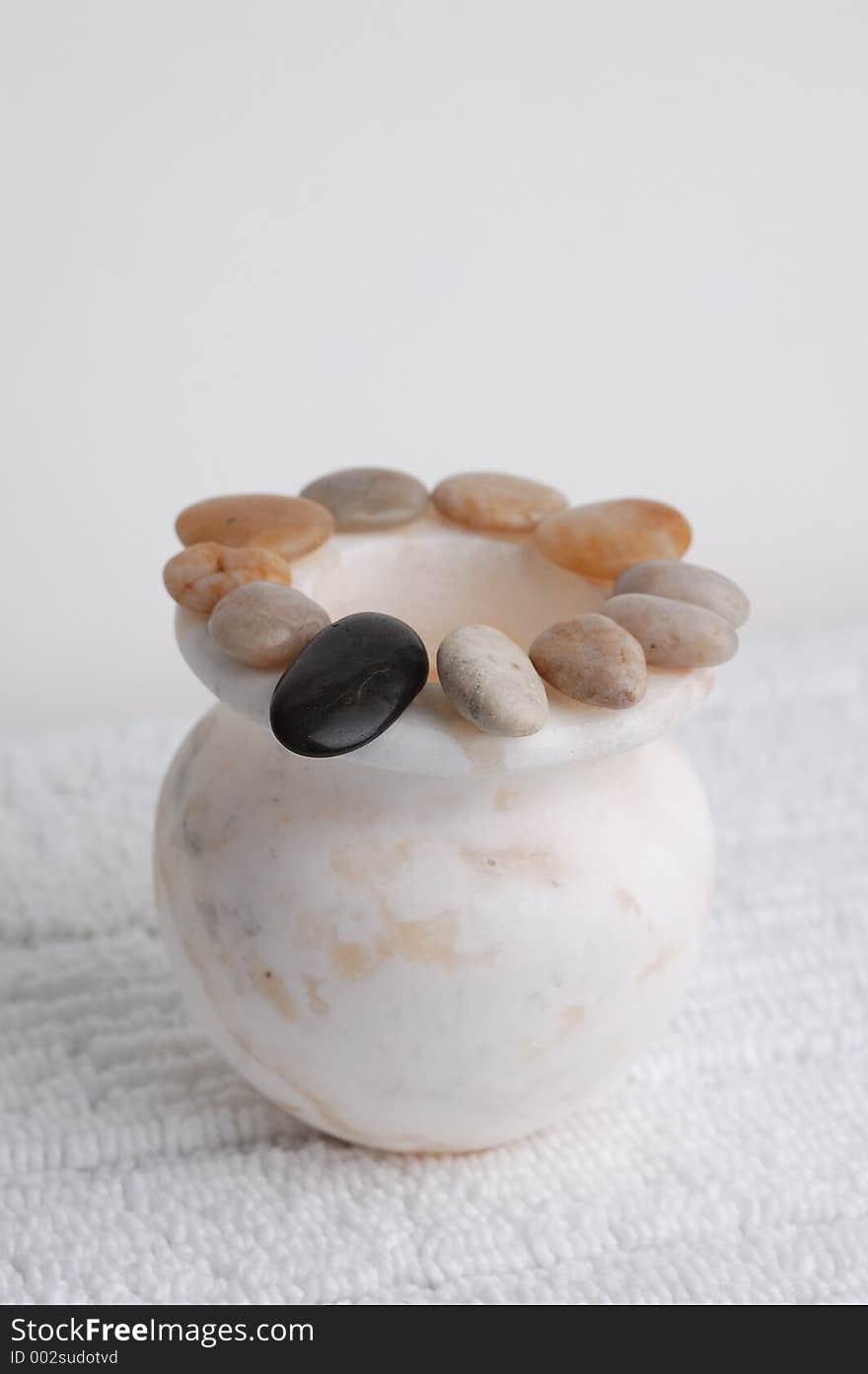 Circle of stones on a marble vase