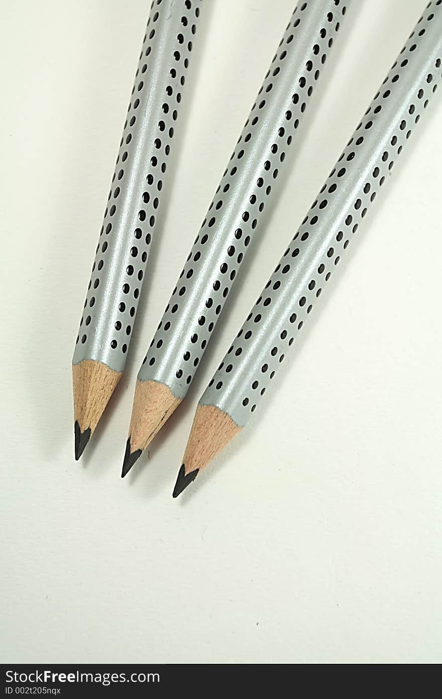 Three grey pencils