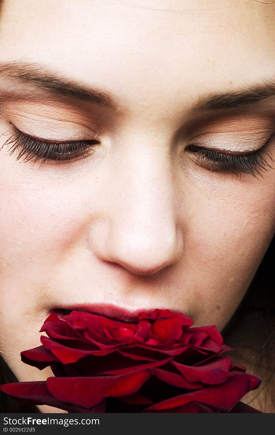 Girl biting a rose