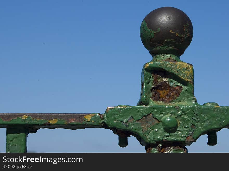 Corroded fence with green paint. Corroded fence with green paint