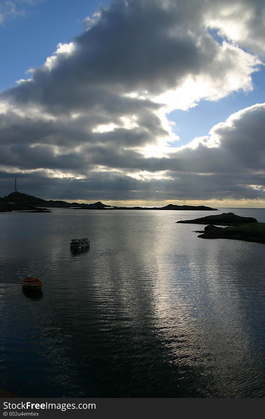 In Aa, Lofoten, northern Norway , the view from the seahouse. The sun was hiding, but the light was streaming through the sky, making the sea look like silver.Behind the sky there's always sunshine. In Aa, Lofoten, northern Norway , the view from the seahouse. The sun was hiding, but the light was streaming through the sky, making the sea look like silver.Behind the sky there's always sunshine...