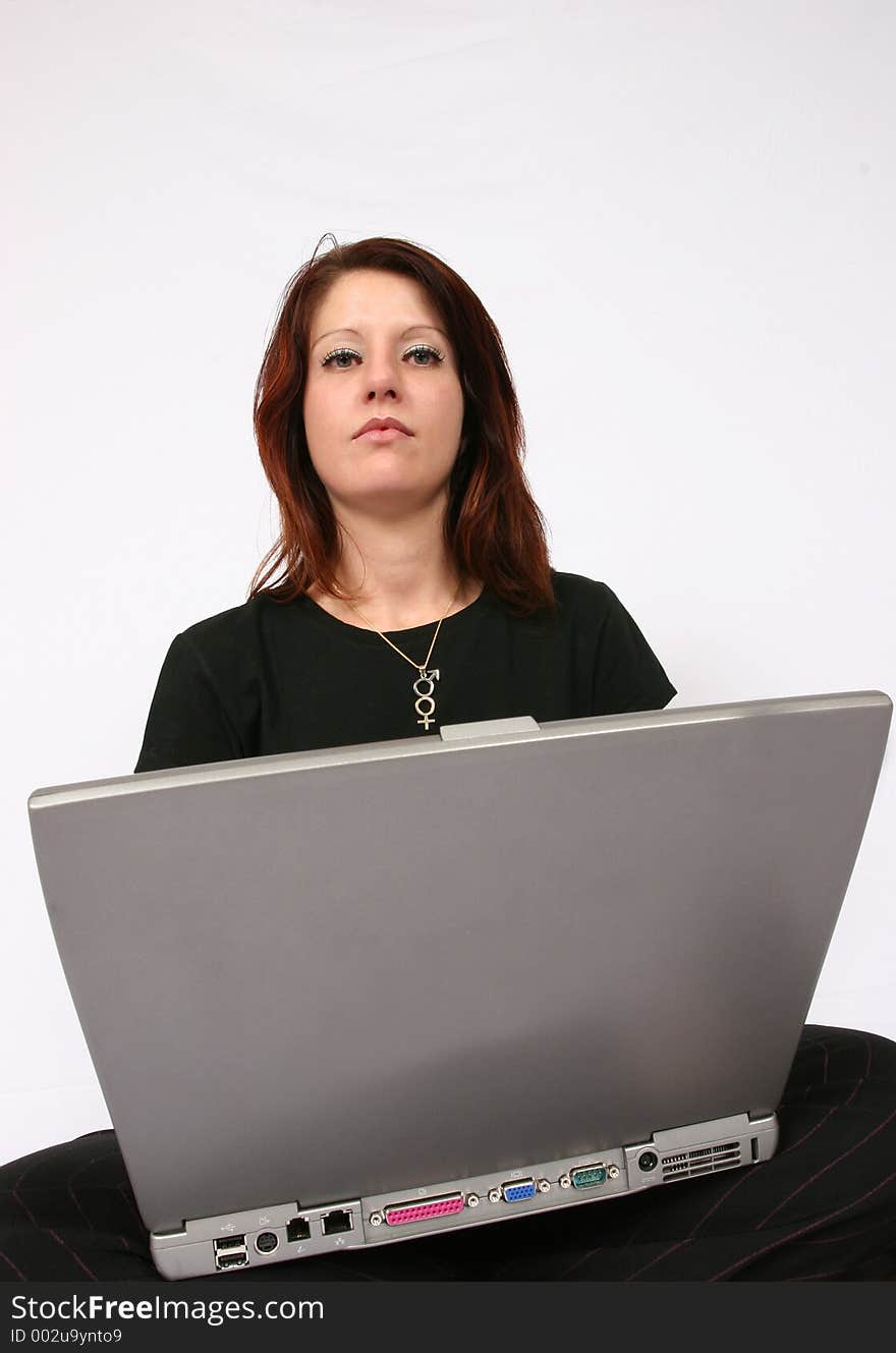 Woman sitting on ground working on her computer