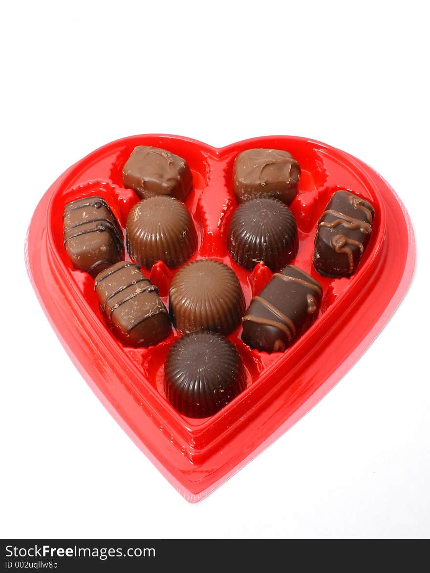 Heart shaped box of chocolates over white. Heart shaped box of chocolates over white