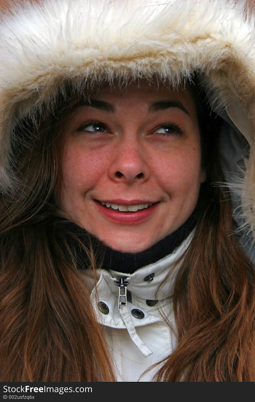 Beautiful girl in a winter hat looking up. Beautiful girl in a winter hat looking up