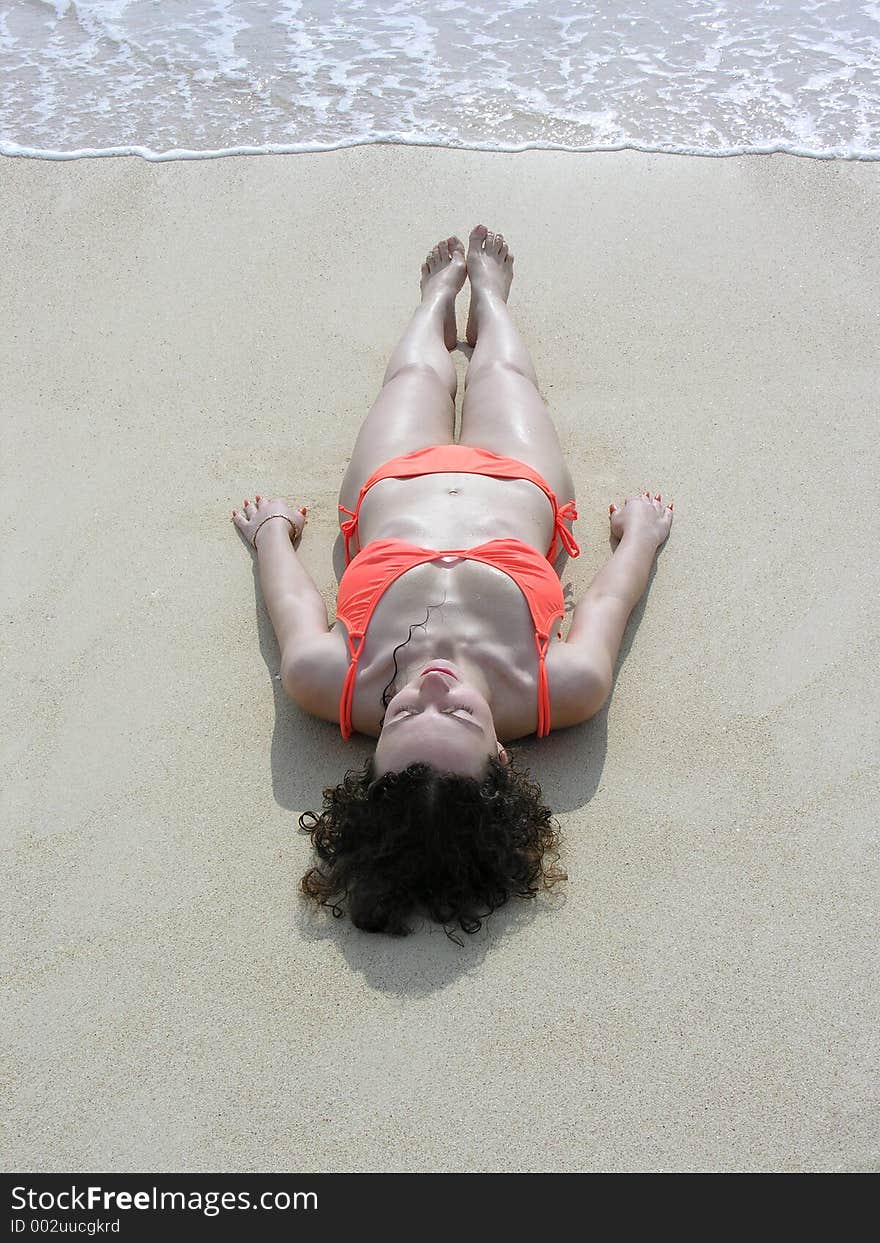 Girl lies on beach